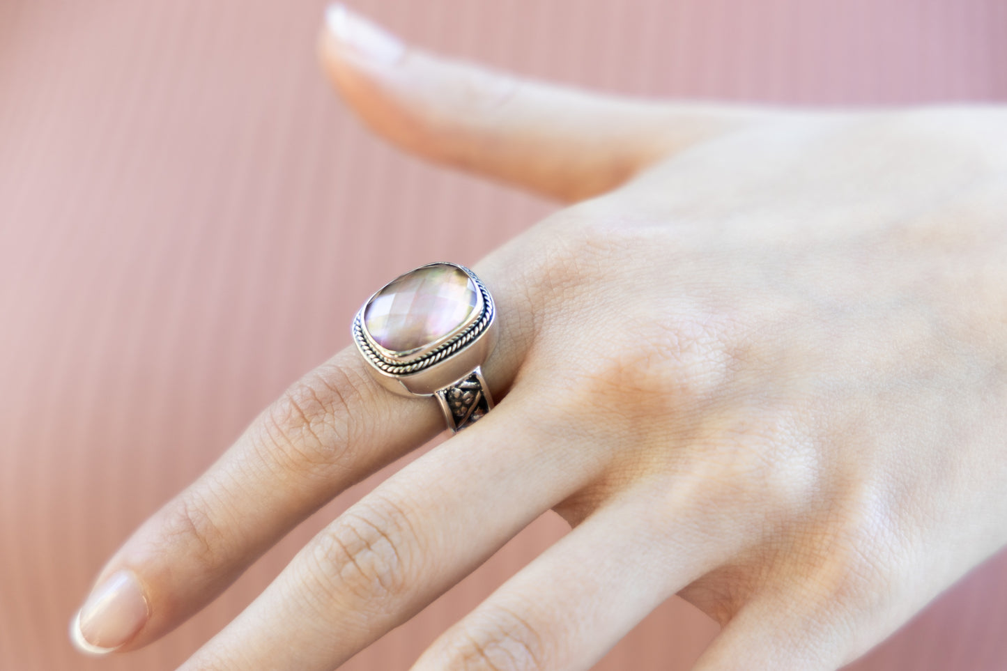 Sterling silver cushion-cut ring with mocha pearl doublet and floral repoussé shank