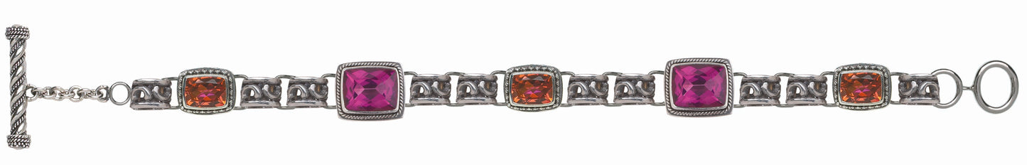 Sterling silver link bracelet with cushion-cut raspberry topaz and twilight topaz in twisted rope and granulation bezels, scroll openwork links, and toggle clasp. Parisian Muse Collection, 2004, Lori Bonn Archive.