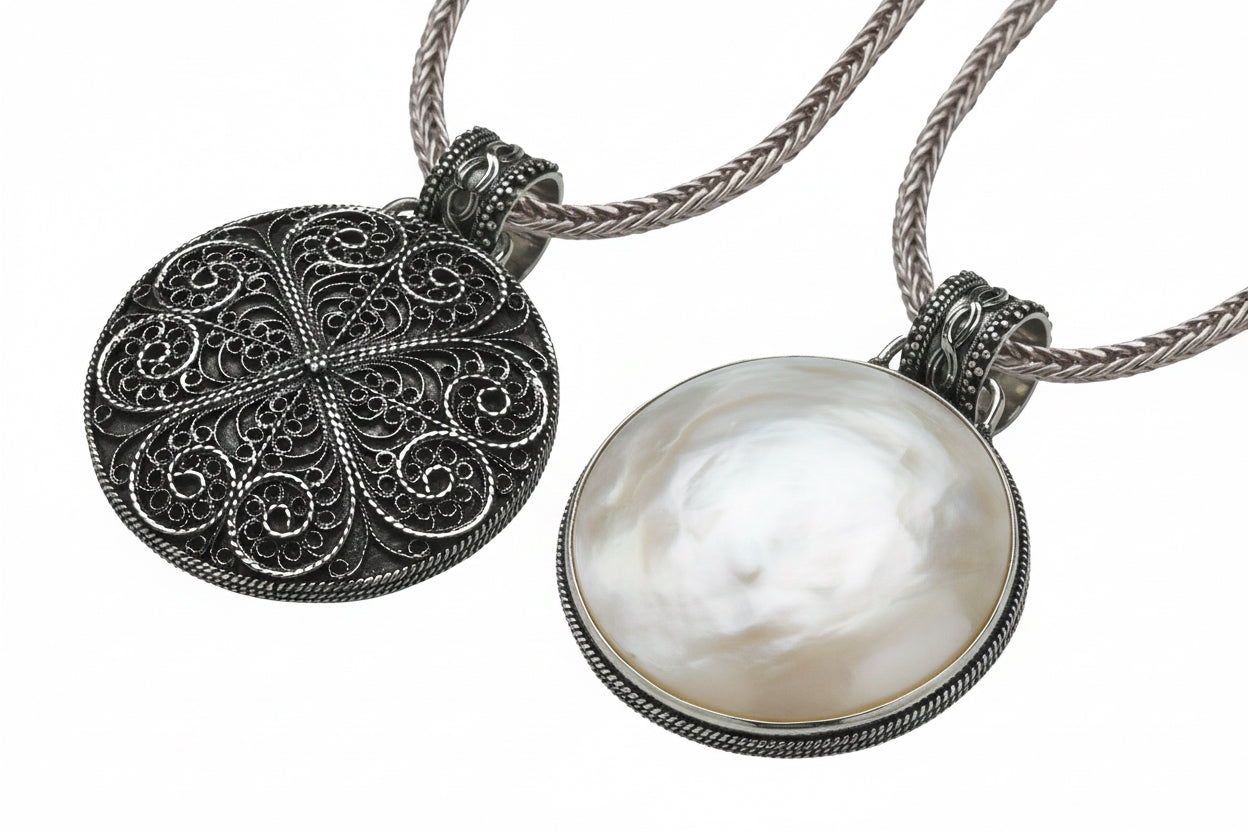Reversible sterling silver pendant with mother of pearl and filigree detailing on an 18-inch handwoven foxtail chain from the Blush 2006 Collection.