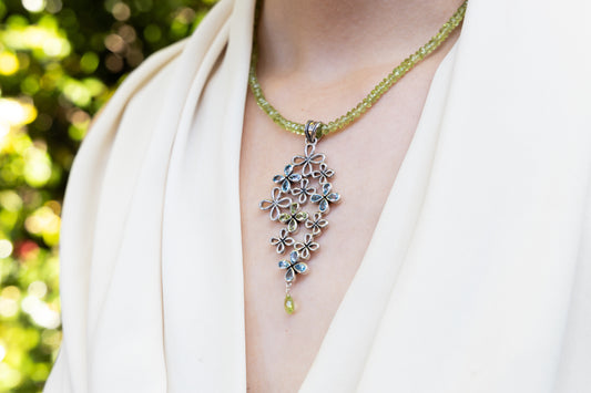 Sterling silver clover cluster pendant with topaz and peridot on faceted bead strand