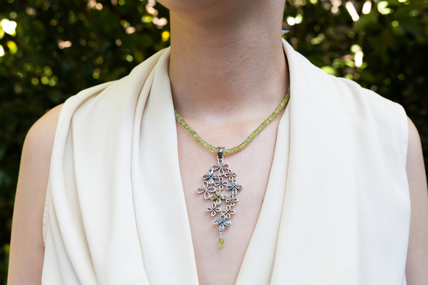 Sterling silver clover cluster pendant with topaz and peridot on faceted bead strand