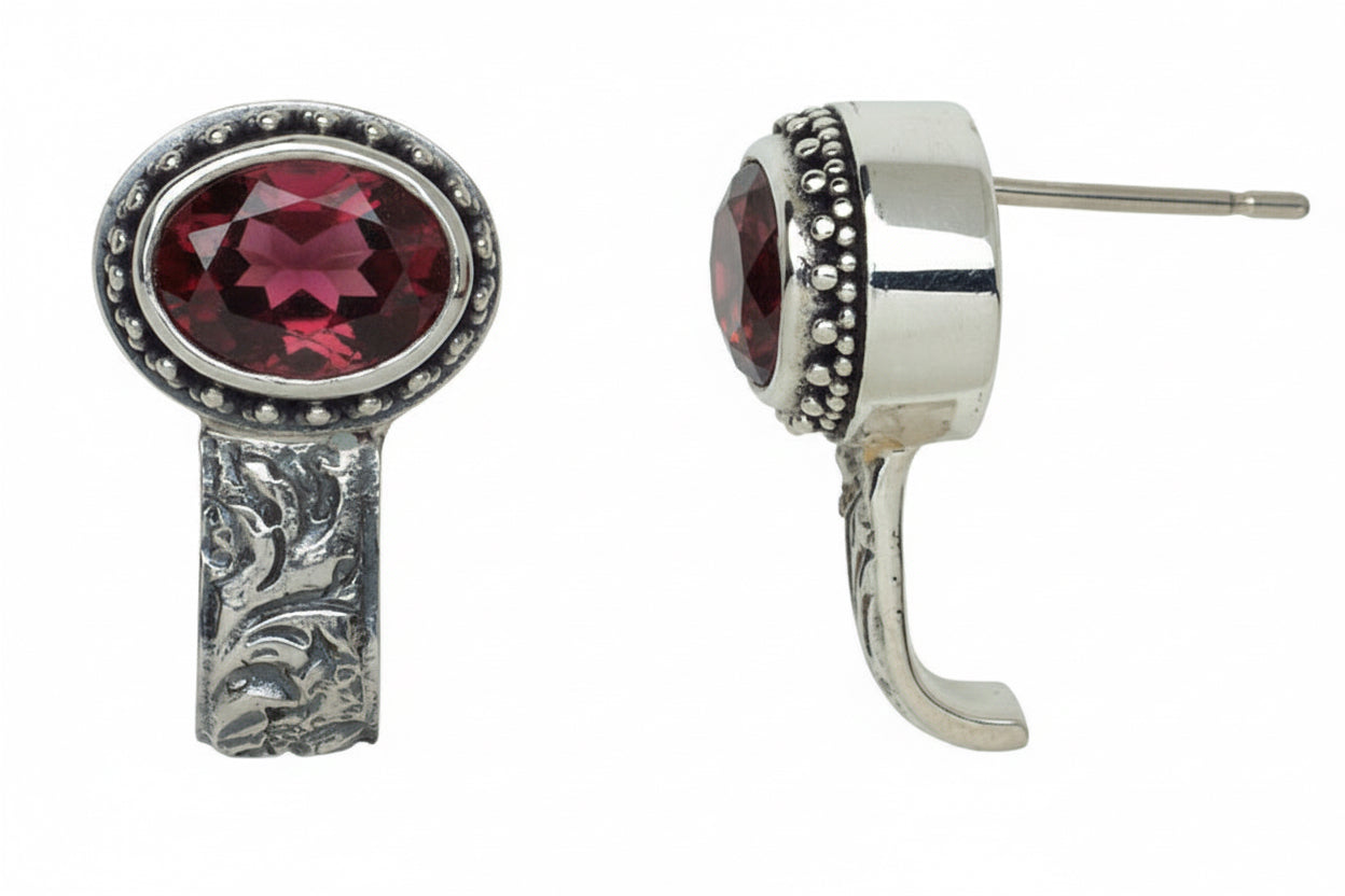 Sterling silver garnet post earrings with beaded bezel and repoussé detailing, approximately ¾" long, from the Sasha 2003 Archive