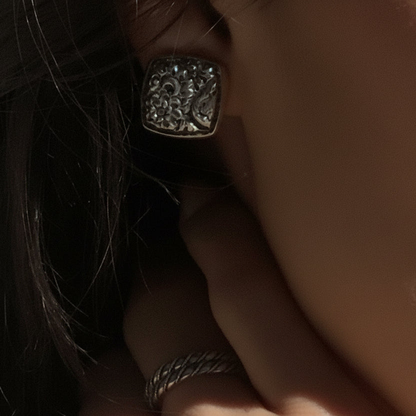 Sterling silver cushion square clip earrings with hand-carved floral repoussé, Sasha Collection 2003, Lori Bonn Archive.