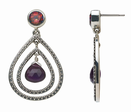 Pair of silver teardrop earrings with gemstones on a white background