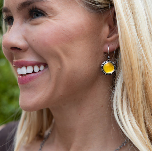 Sterling silver round wire earrings with polished black mother of pearl drops.