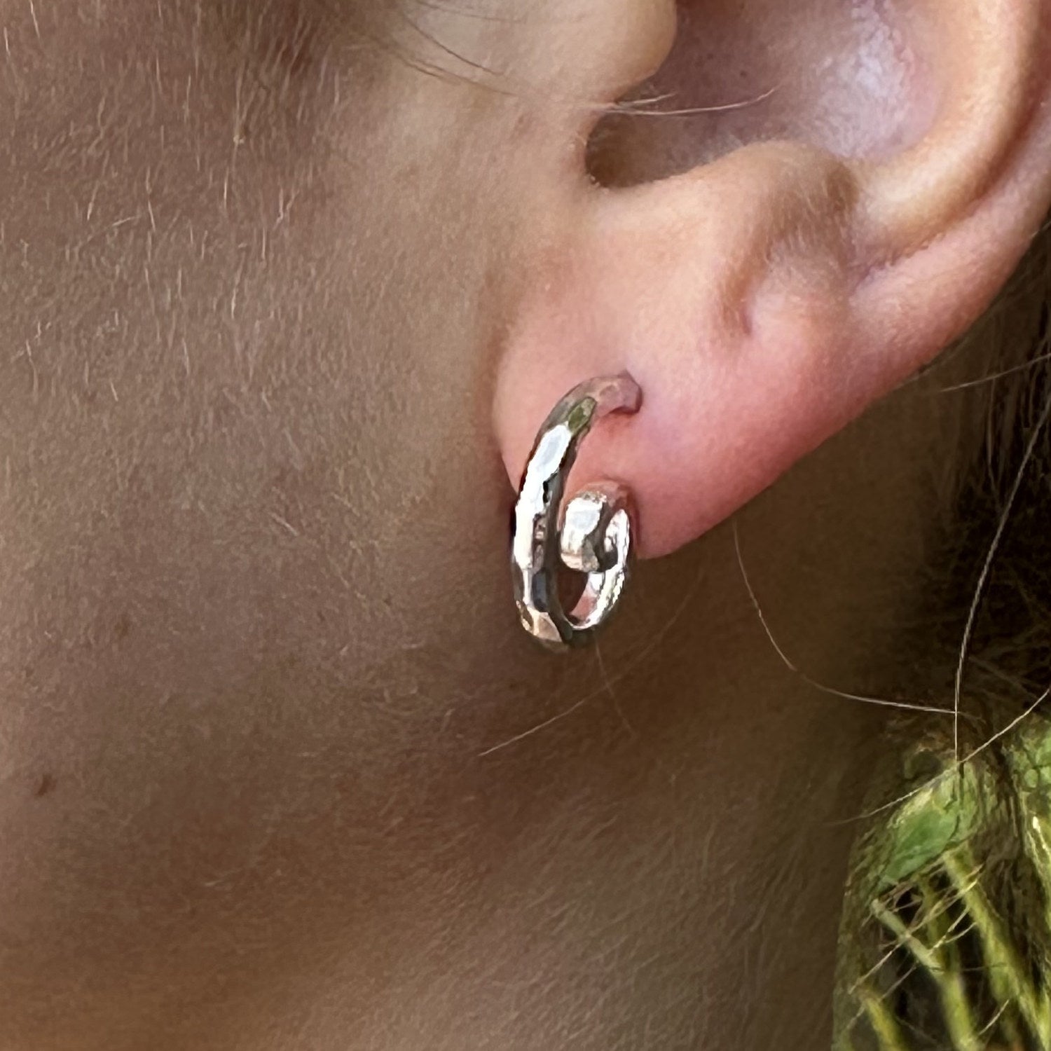Sterling silver hand-hammered swirl hoop earring worn without the charm drop, Lori Bonn Splash Collection 2009 Archive sample.