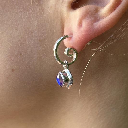 Sterling silver hand-hammered swirl hoop earring with removable cushion-cut rainbow lavender quartz charm drop, worn, Lori Bonn Splash Collection 2009 Archive sample.