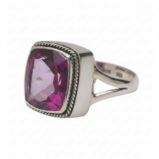 Sterling silver cocktail ring with 12x10mm cushion-cut raspberry topaz in a twisted rope frame bezel and split shank, size 8. Parisian Muse Collection, 2004, Lori Bonn Archive.