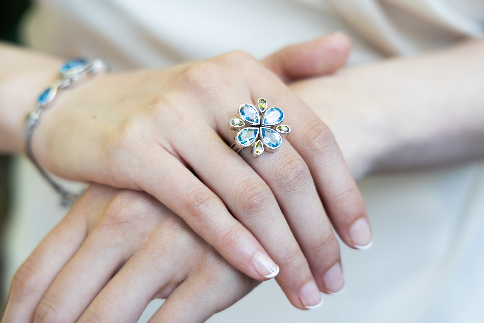 Sterling silver flower ring with blue topaz and peridot, smooth finish, sizes 7 and 8