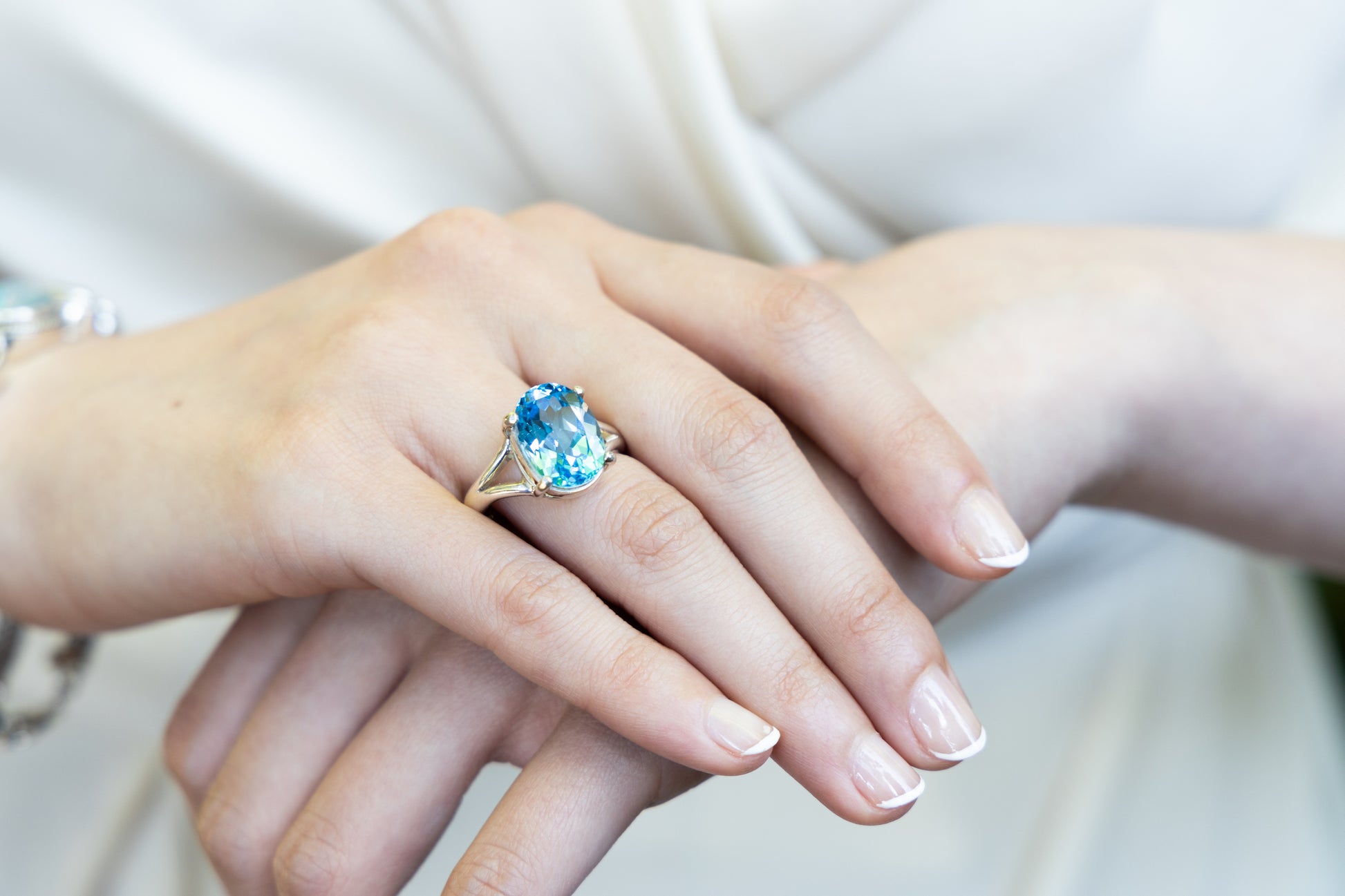 Oval blue topaz ring with prong setting and simple silver band, sizes 7 and 9