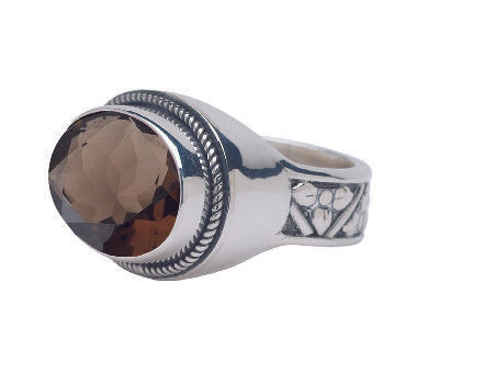 Sterling silver ring with faceted oval smoky quartz and floral repoussé shank pattern