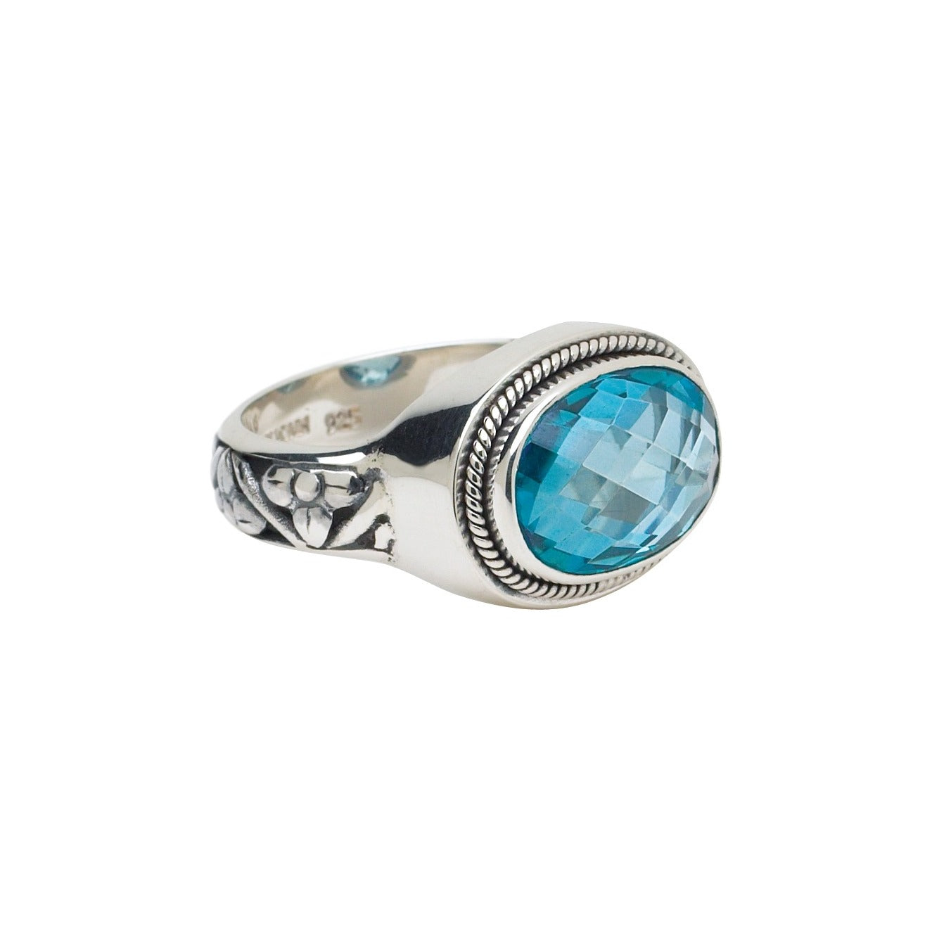 Sterling silver cocktail ring with oval light blue spinel and hand-tapped repoussé flower shank, size 8, Lori Bonn Peacock Collection 2005 Archive.