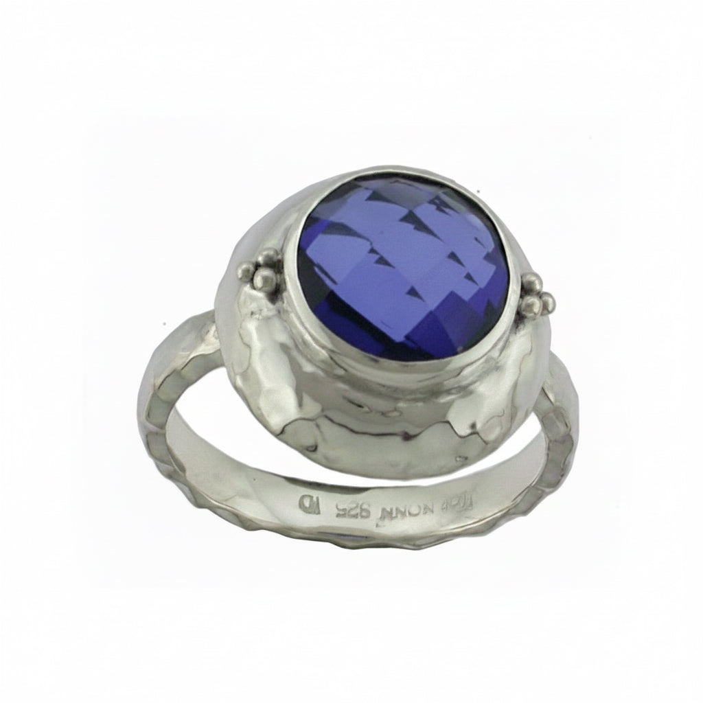 Sterling silver ring with 10mm checkerboard-cut created blue sapphire in hand-hammered bezel and shank, Windsor Collection 2009, Lori Bonn Archive.