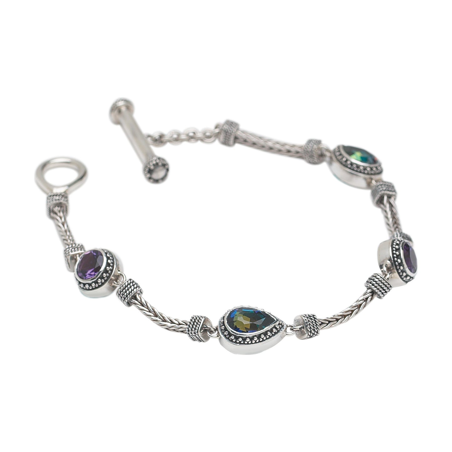 Sterling silver handwoven foxtail chain bracelet with pear and round amethyst and mystic fire topaz stations, toggle clasp, Lori Bonn Heirloom Collection 2002 Archive.