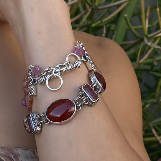 Sterling silver multi-stone link bracelet with carnelian oval cabochons, deep twilight topaz baguettes, and garnet rounds with granulated bezels and twisted rope toggle closure, Sasha Collection 2003, Lori Bonn Archive.