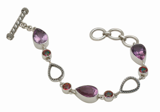 Sterling silver link bracelet with three pear-cut amethysts, round twilight topaz, and granulated open teardrop links with toggle closure, Parisian Muse Collection 2004, Lori Bonn Archive