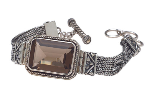 Sterling silver multistrand bracelet with large smoky quartz center and repoussé side panels