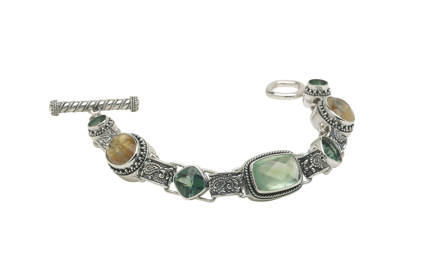 Sterling silver bracelet with prehnite, green spinel, and rutilated quartz linked by paisley repoussé connectors.