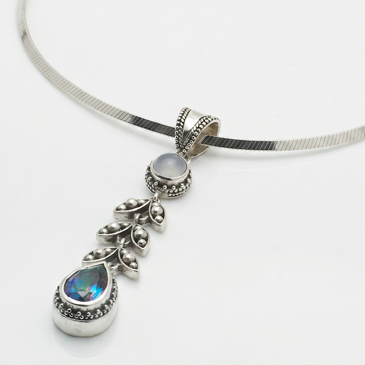 Sterling silver pendant necklace with chalcedony cabochon, granulated leaf vine link, and pear-shaped mystic fire topaz on square magic chain, Heirloom Collection 2002, Lori Bonn Archive.