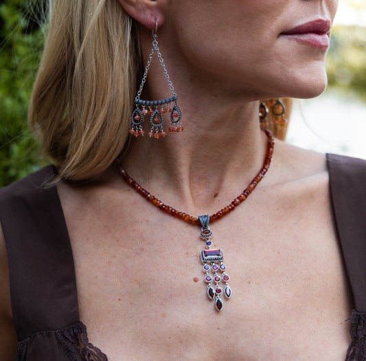 Sterling silver chandelier enhancer pendant with amber, garnet, and deep twilight topaz on an adjustable 16–18 inch faceted hessonite bead necklace from the Sasha 2003 Archive.