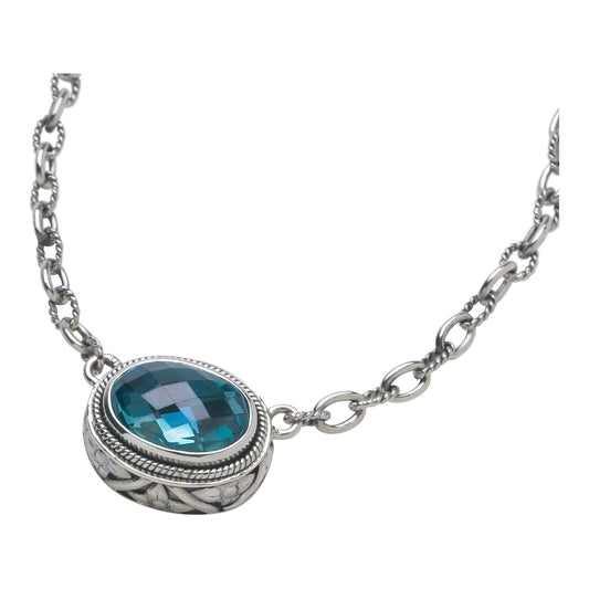 Sterling silver necklace with horizontal oval light blue spinel in repoussé-detailed bezel on extendable chain, Lori Bonn Peacock Collection 2005 Archive.