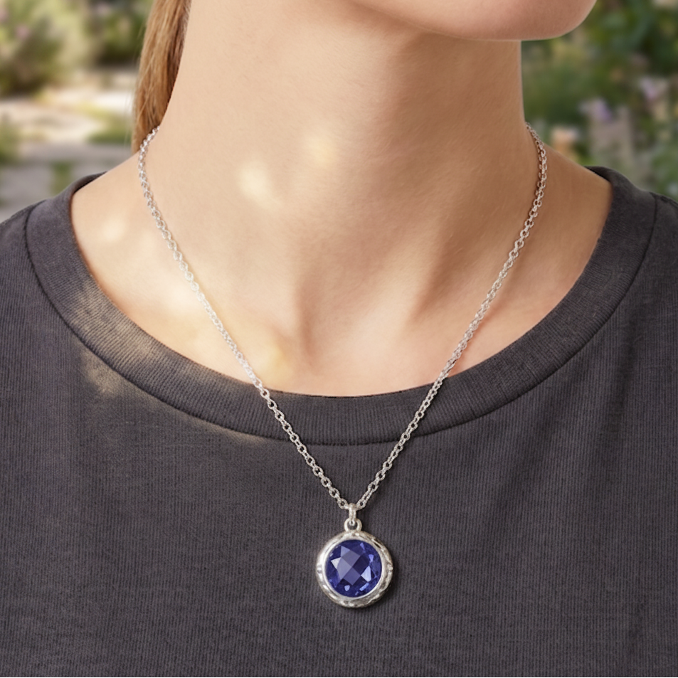 Sterling silver pendant necklace with large checkerboard-cut created blue sapphire in hand-hammered bezel on chain, Windsor Collection 2009, Lori Bonn Archive.
