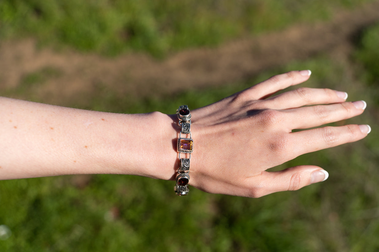 Sterling silver link bracelet with twilight and gypsy red topaz stones and filigree links