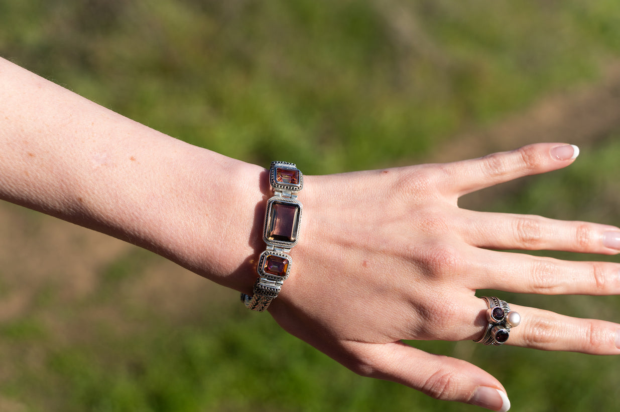 Sterling silver bracelet with rectangular twilight topaz and smoky quartz, linked by silver ikat patterns