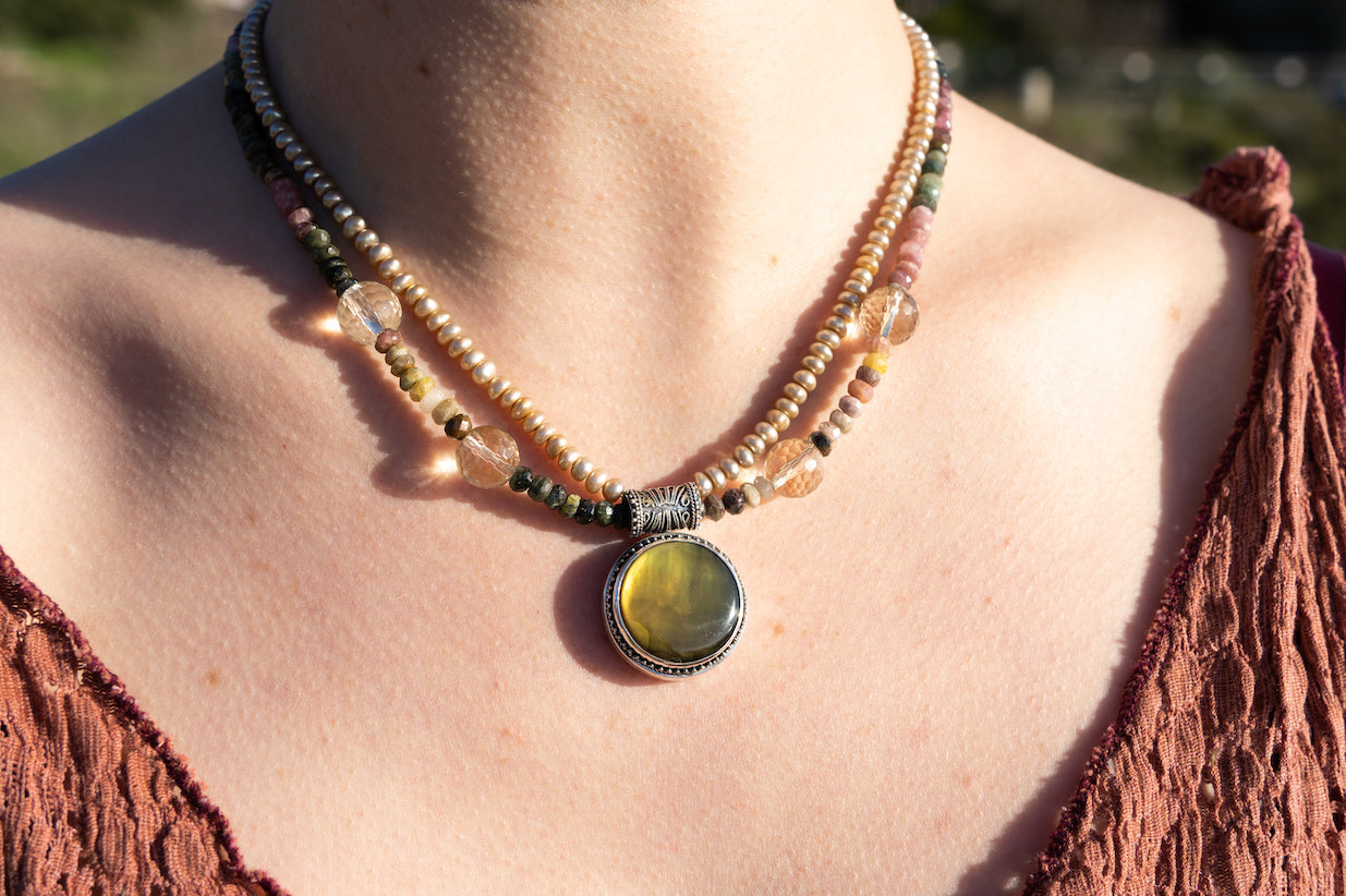 Pendant necklace with large black mother of pearl on tourmaline, pearl, and oro verde quartz double strand