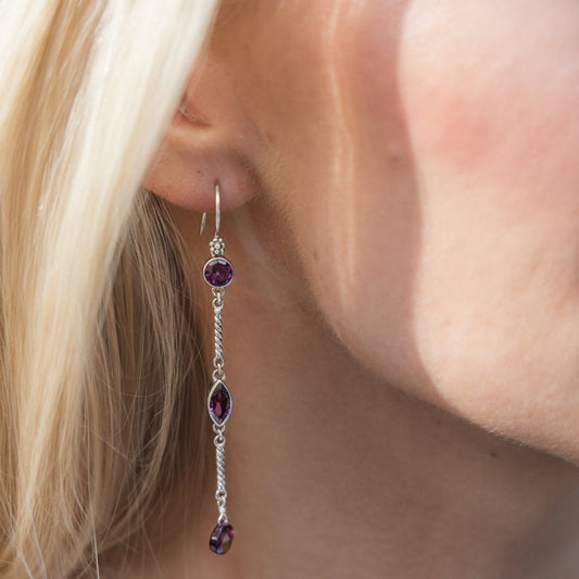 One-of-a-kind sterling silver linear drop earrings with faceted garnet stones from the Sasha 2003 Archive.