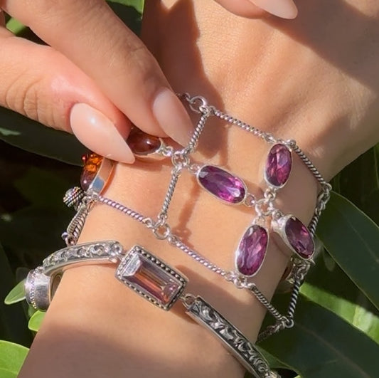 Sterling silver three-strand oval flower link bracelet with amber and raspberry topaz and twisted rope bar links with toggle closure, Parisian Muse Collection 2004, Lori Bonn Archive.