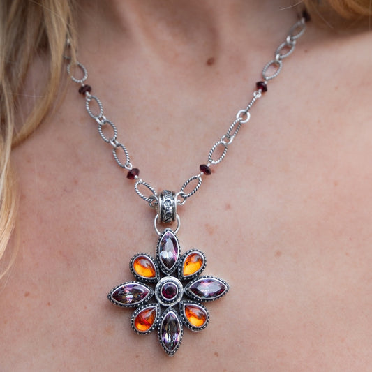 Sterling silver floral pendant featuring garnet, amber, and deep twilight topaz on an adjustable handmade chain from the Sasha 2003 Archive.