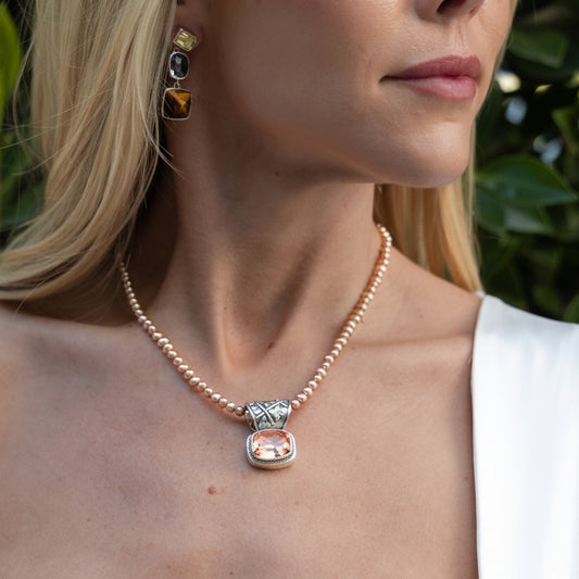 Sterling silver pendant necklace with rose gold quartz doublet and repoussé detailing on an adjustable pearl strand from the Cognac 2005 Archive.
