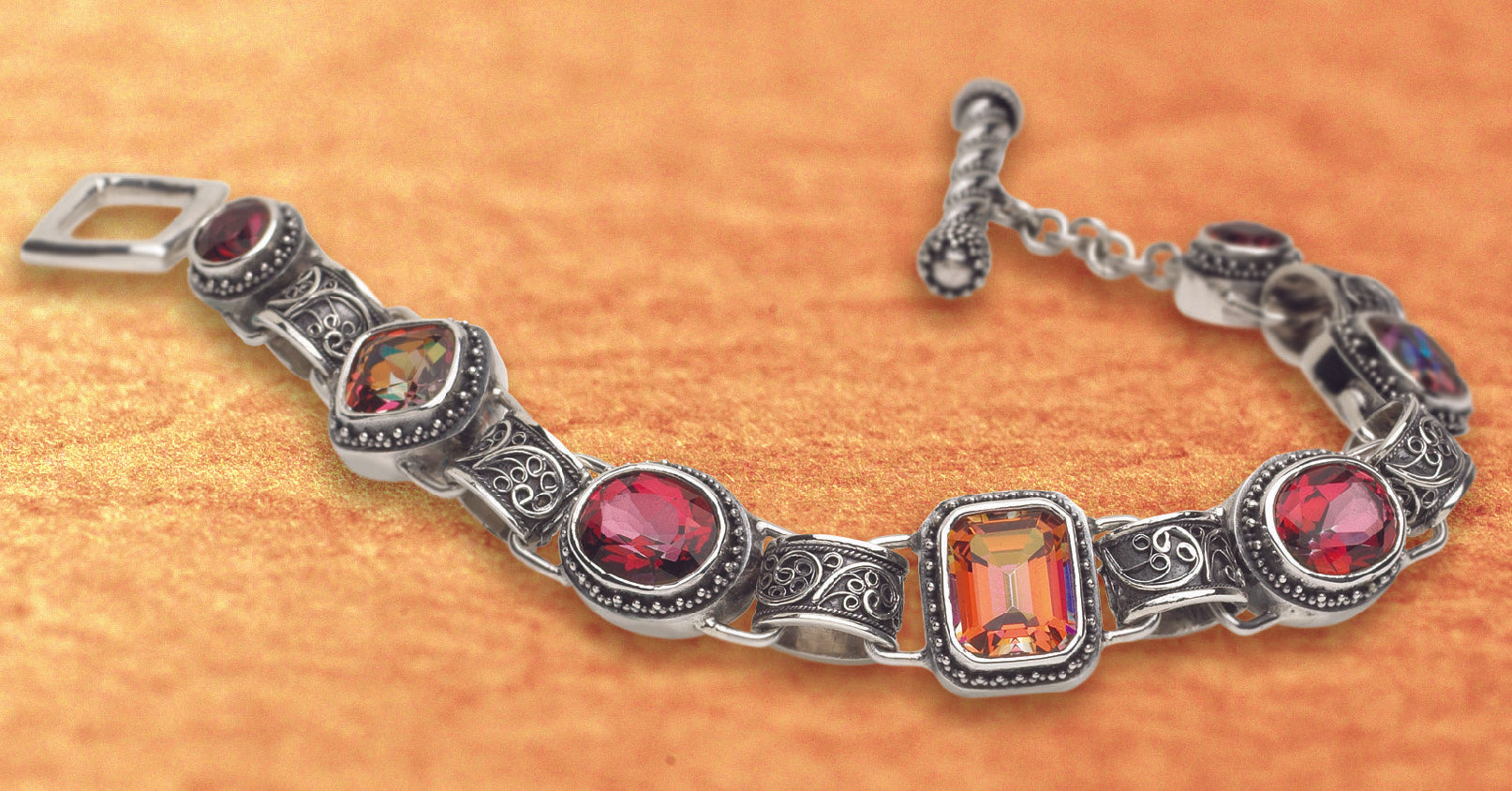 Sterling silver link bracelet with twilight and gypsy red topaz stones and filigree links