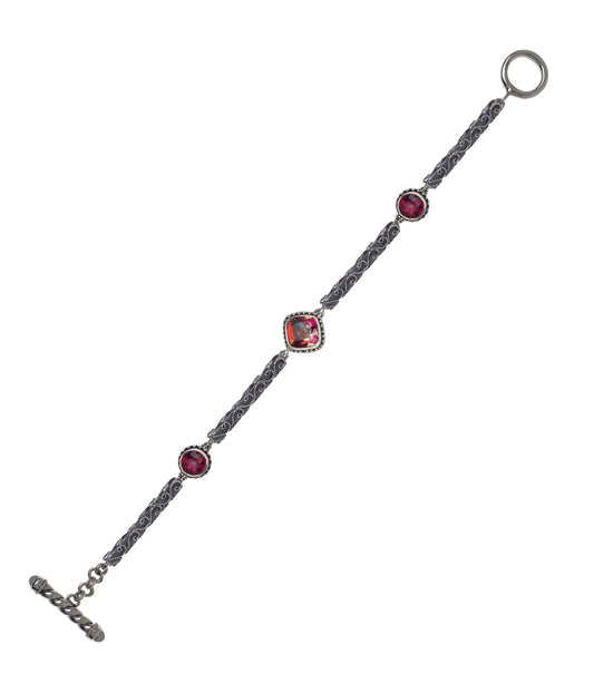 Sterling silver bracelet with gypsy red topaz and twilight topaz, linked by filigree bar panels